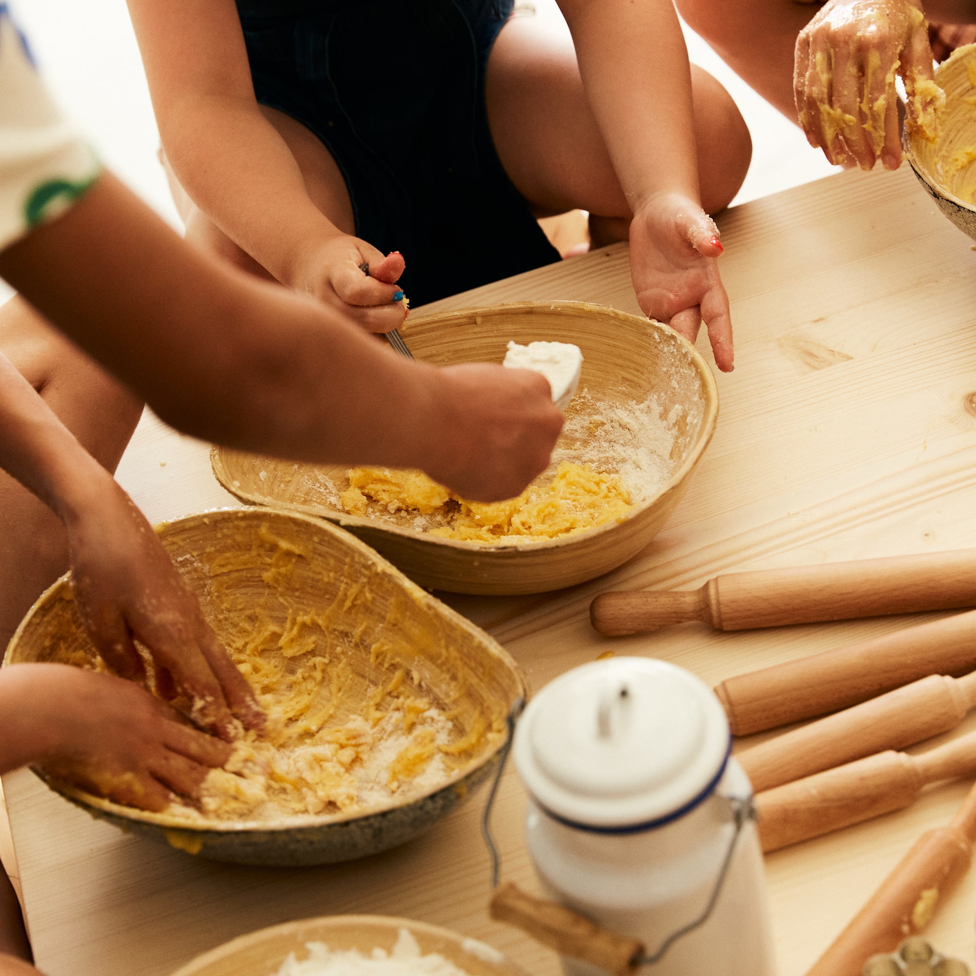 a group of people making dough