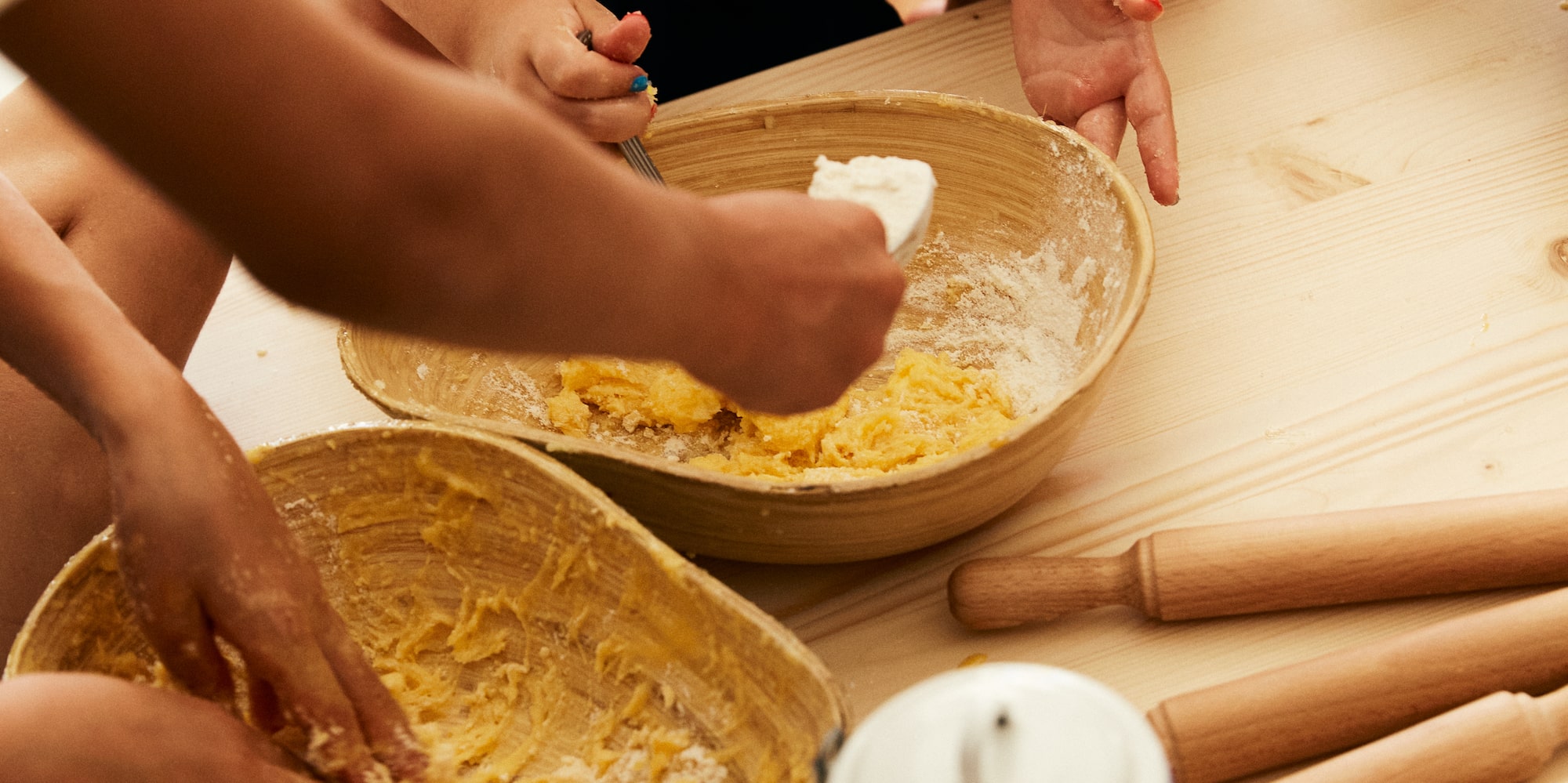 a group of people making dough