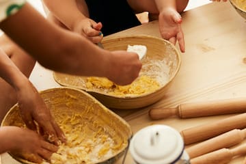 a group of people making dough