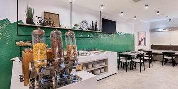 a room with a variety of cereals and a green wall