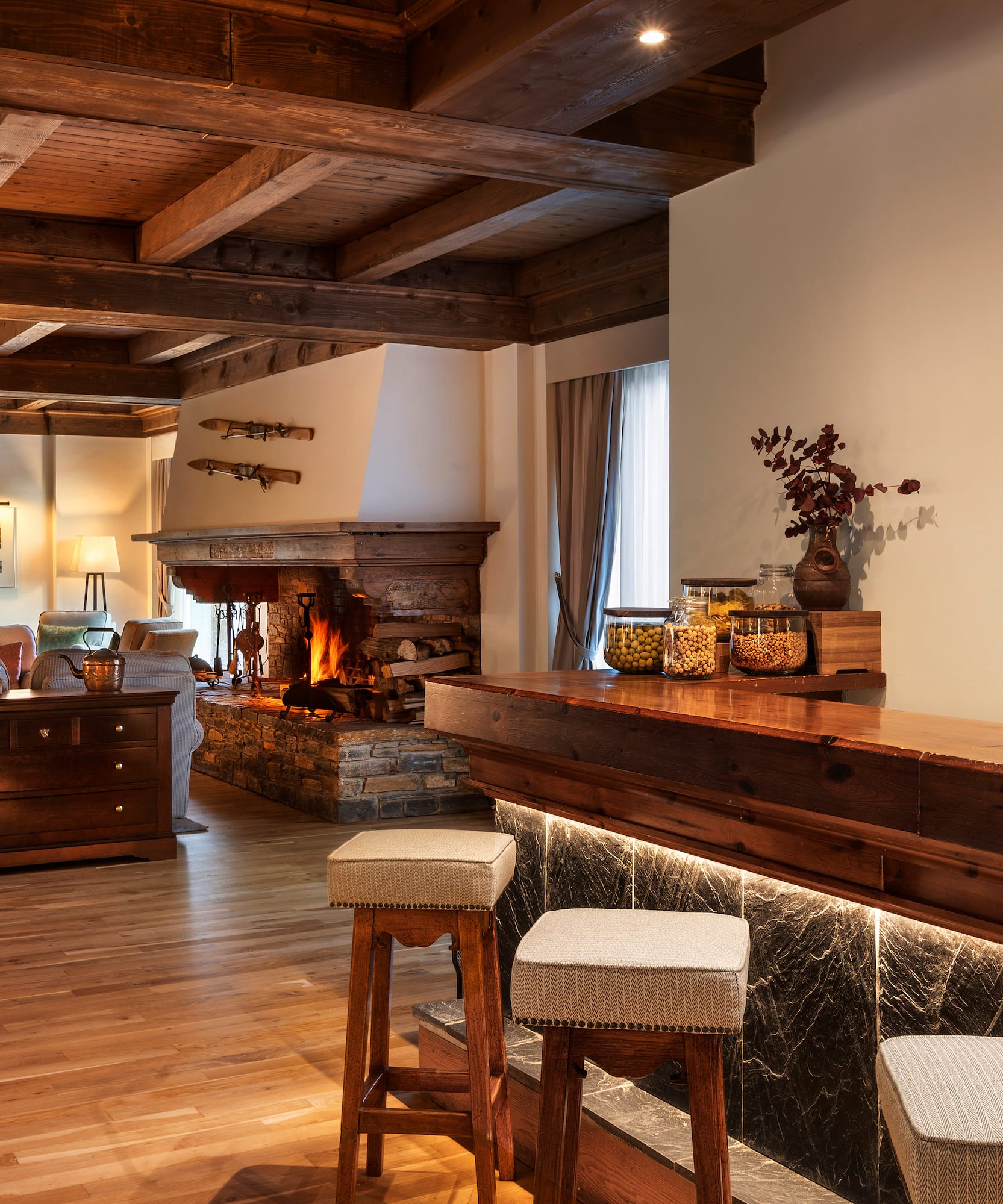 a room with a bar and a fireplace