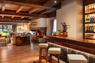 a room with a bar and a fireplace