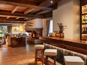 a room with a bar and a fireplace