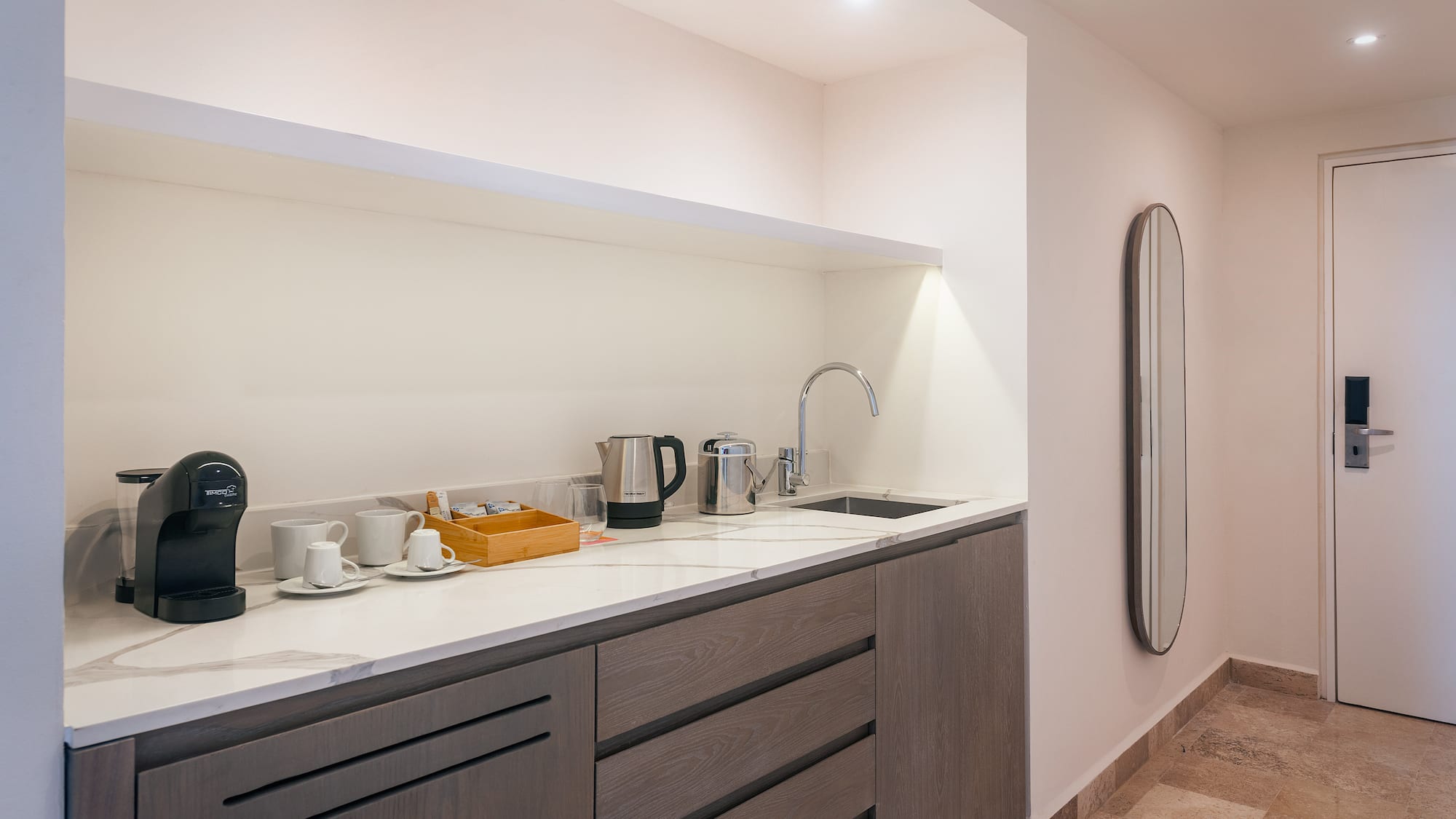 a kitchen with a sink and coffee cups