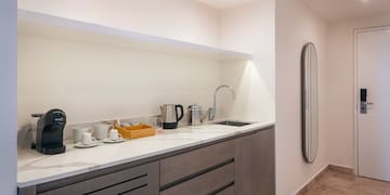 a kitchen with a sink and coffee cups