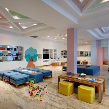 a room with a large table and benches