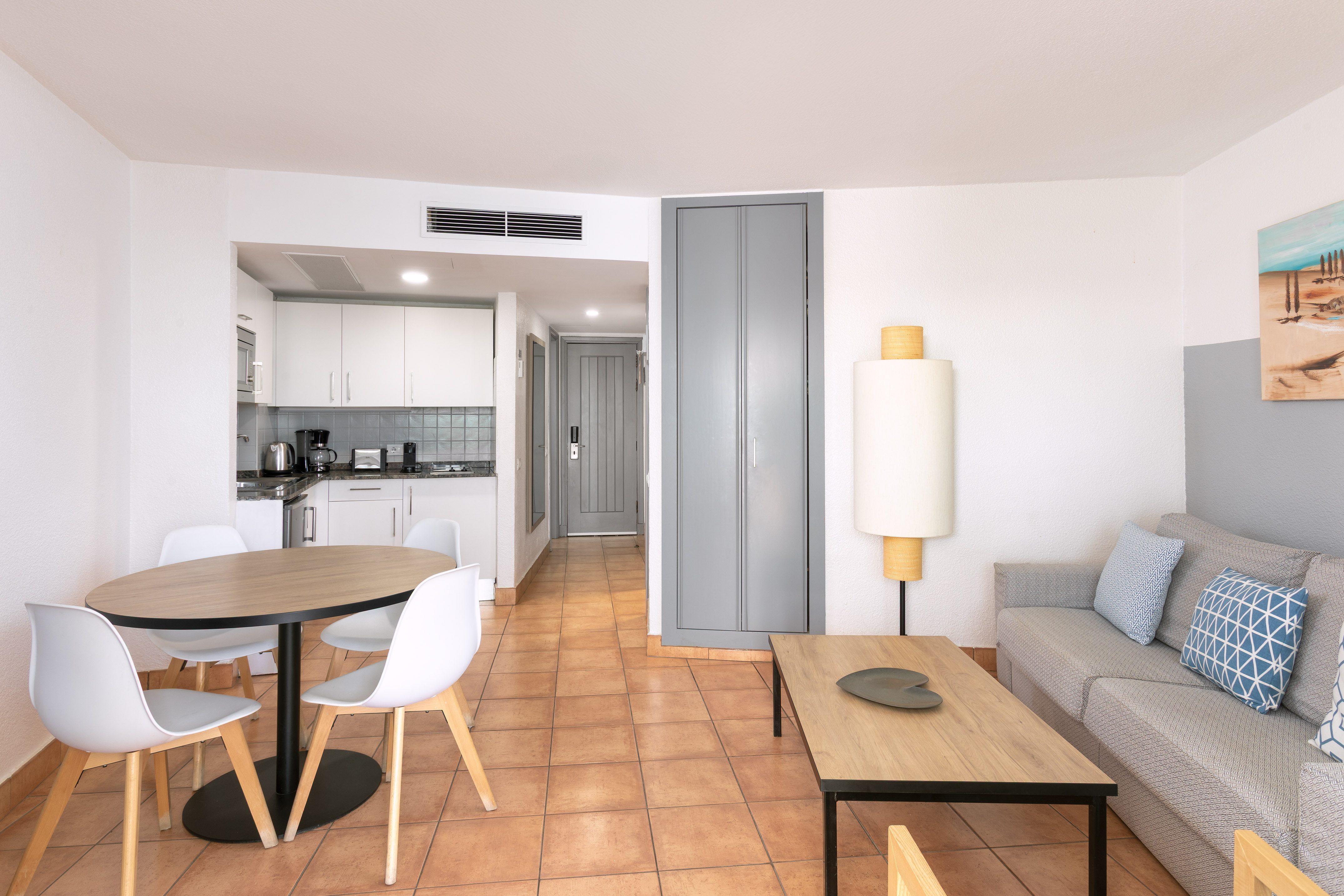 Modern apartment living room and kitchen with dining area.