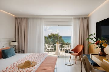 a room with a bed and chairs and a table and chairs