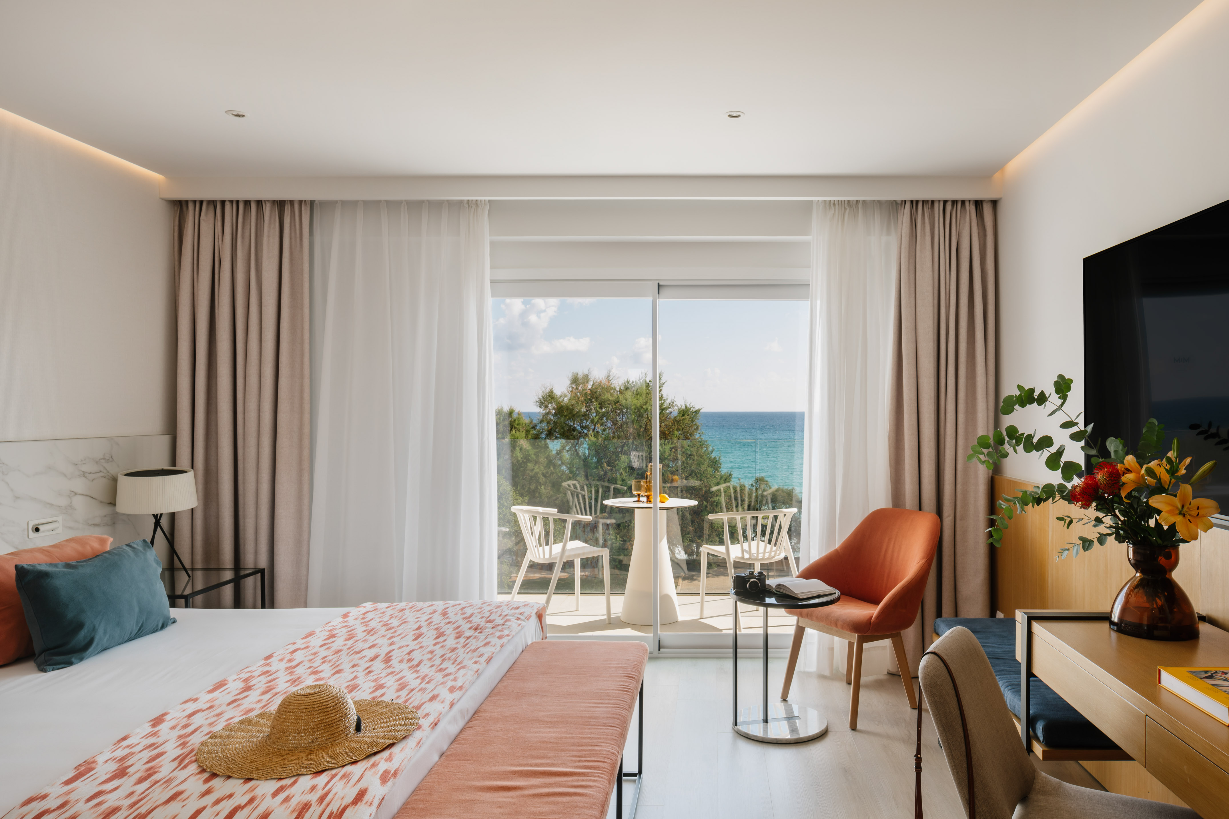 a room with a bed and chairs and a table and chairs