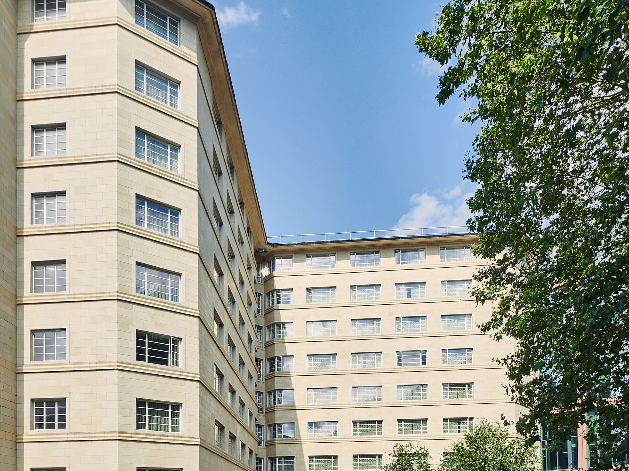 a building with trees and a blue sky