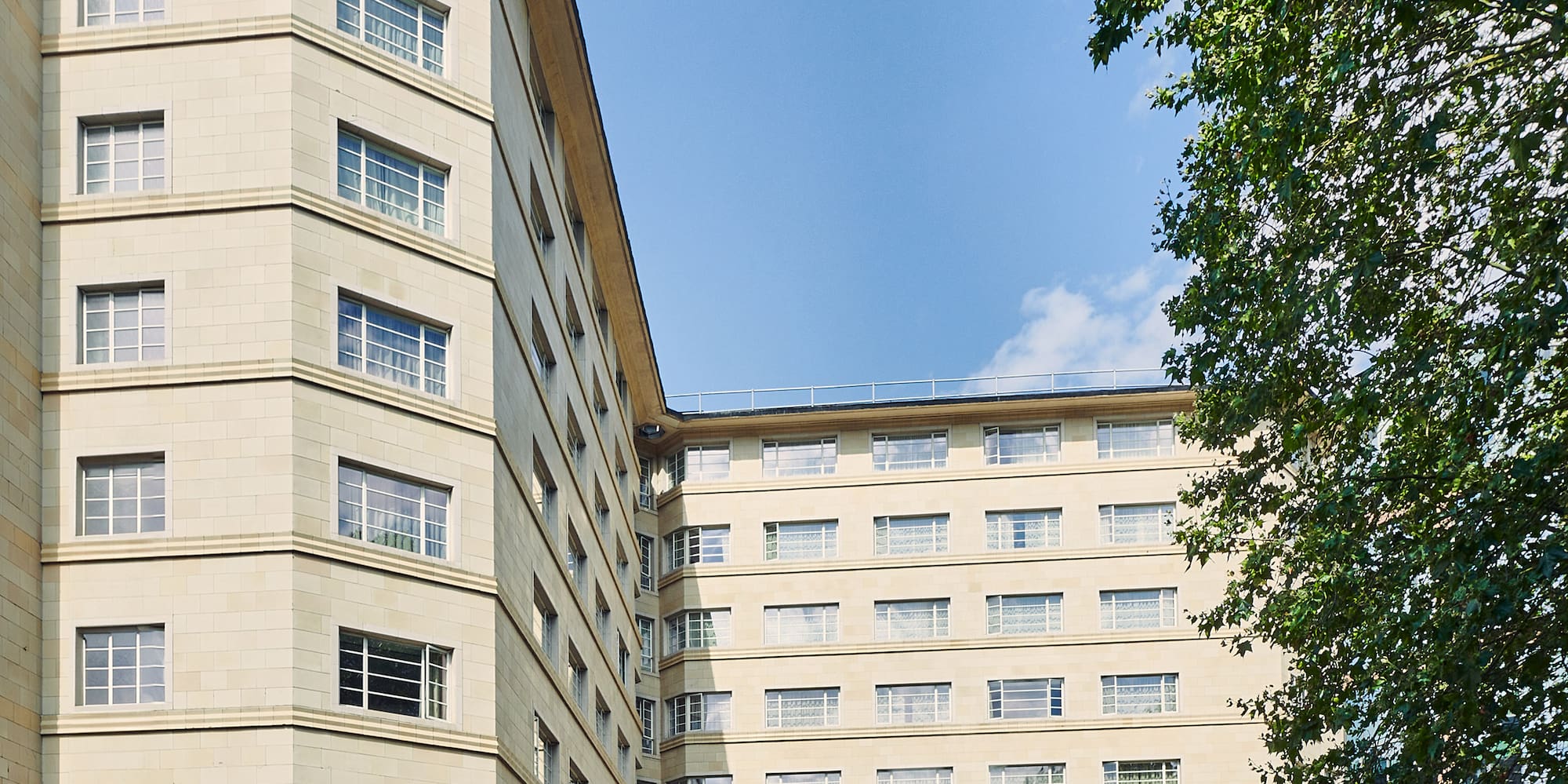 a building with trees and a blue sky