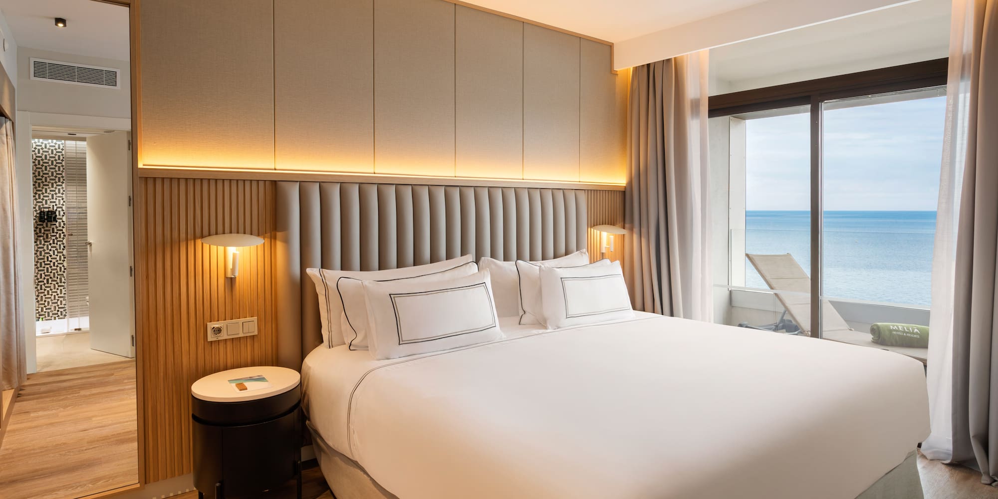 a bed with a window overlooking the ocean