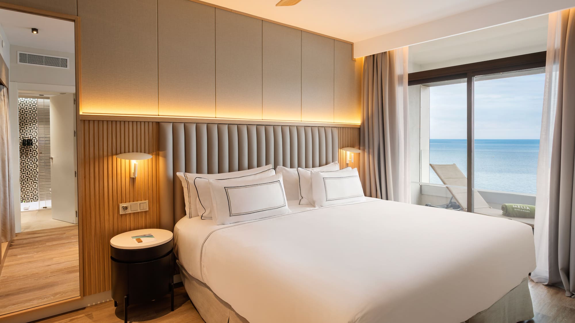 a bed with a window overlooking the ocean