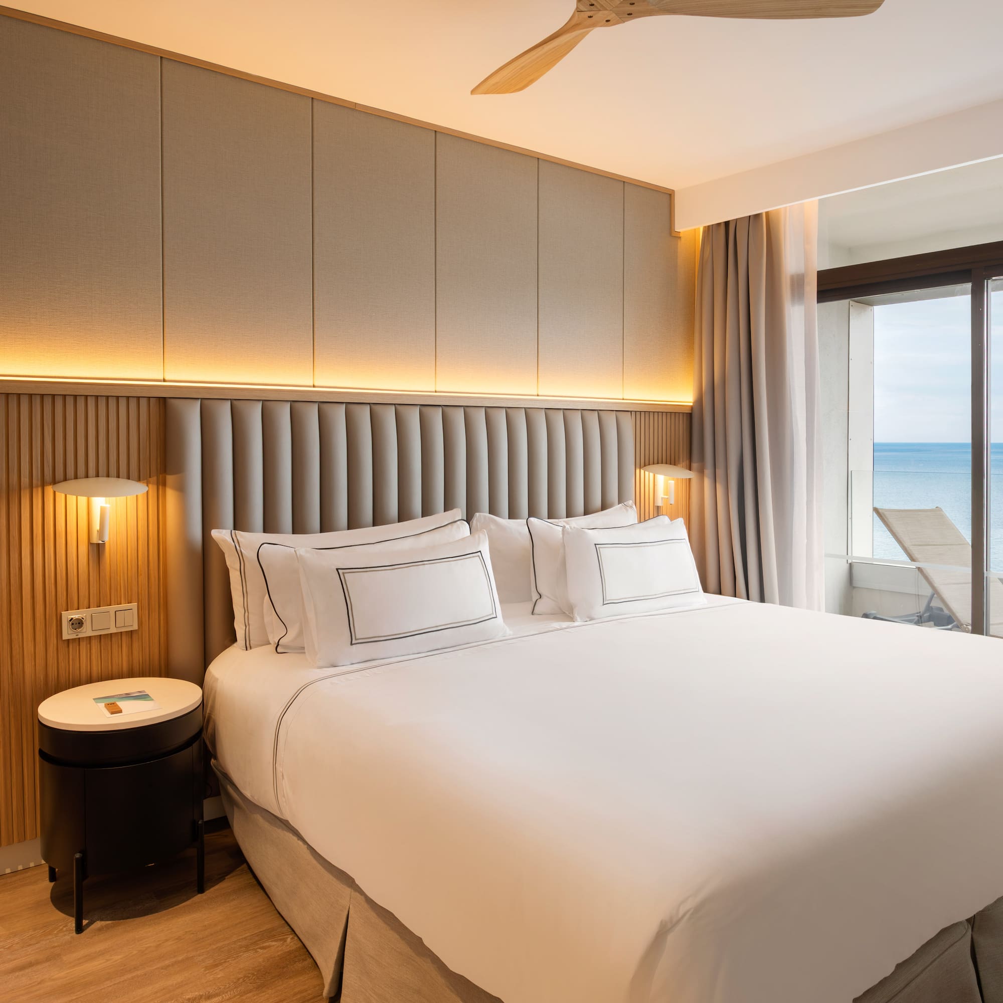 a bed with a window overlooking the ocean