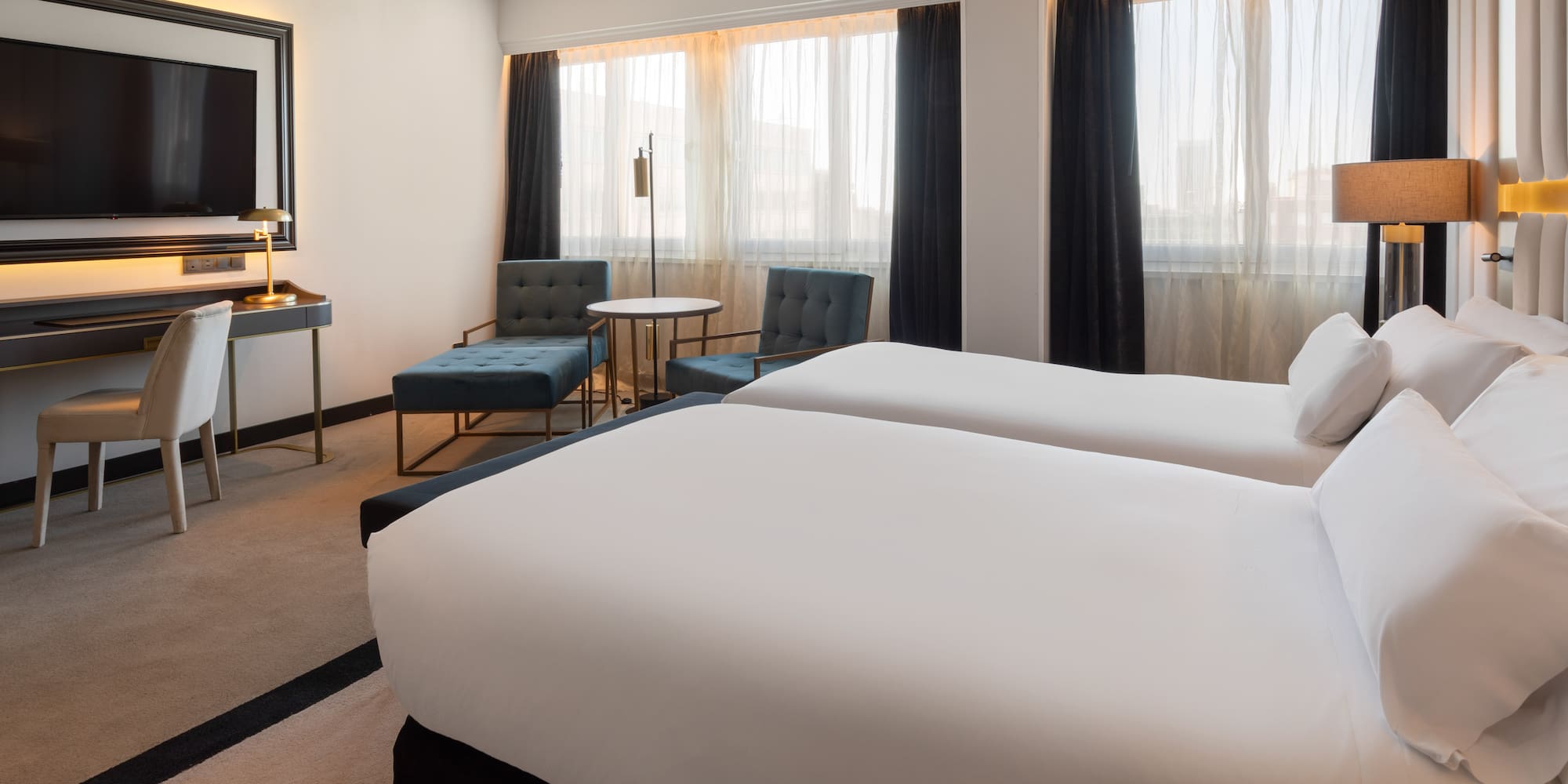 a hotel room with two beds and a table