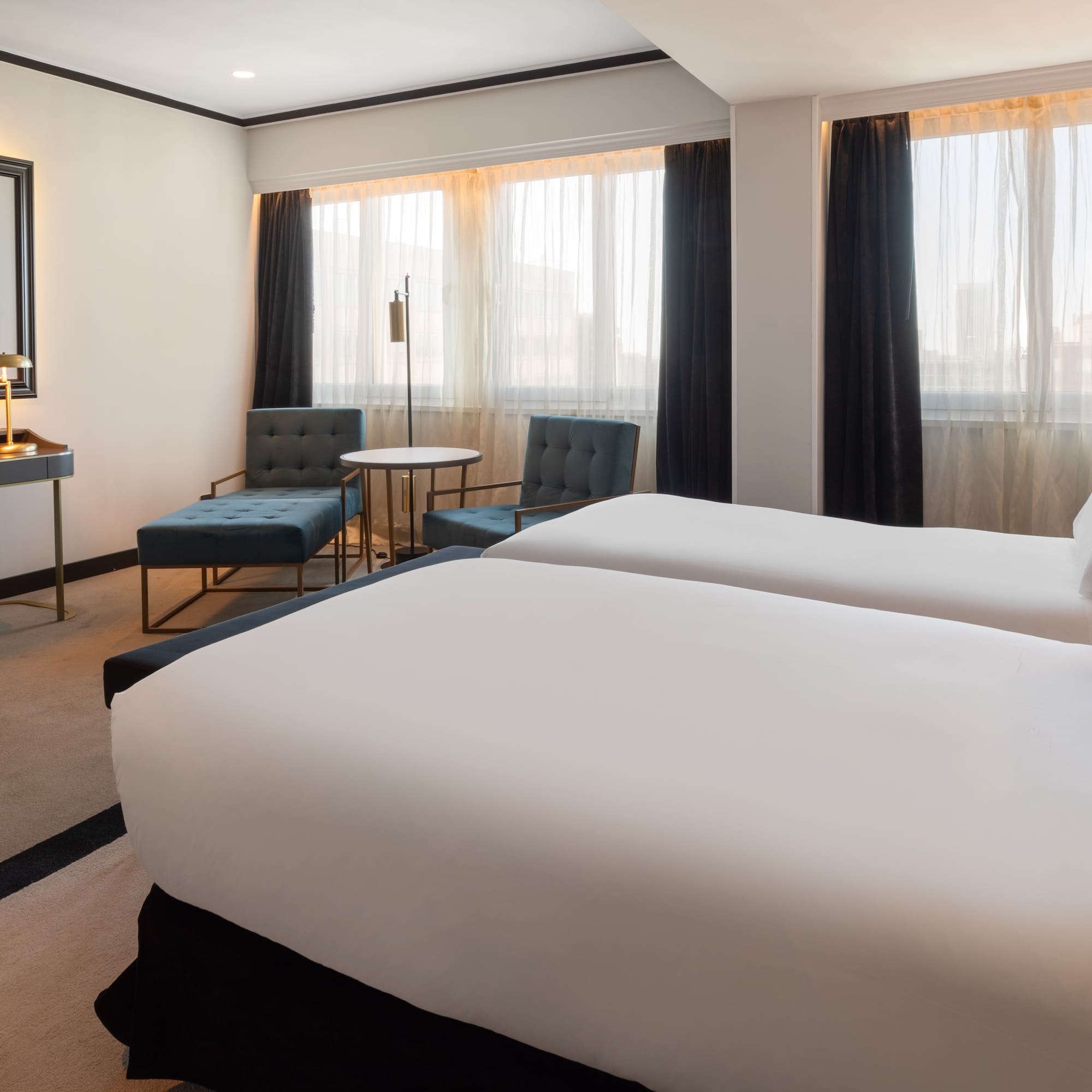 a hotel room with two beds and a table