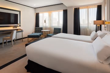 a hotel room with two beds and a table