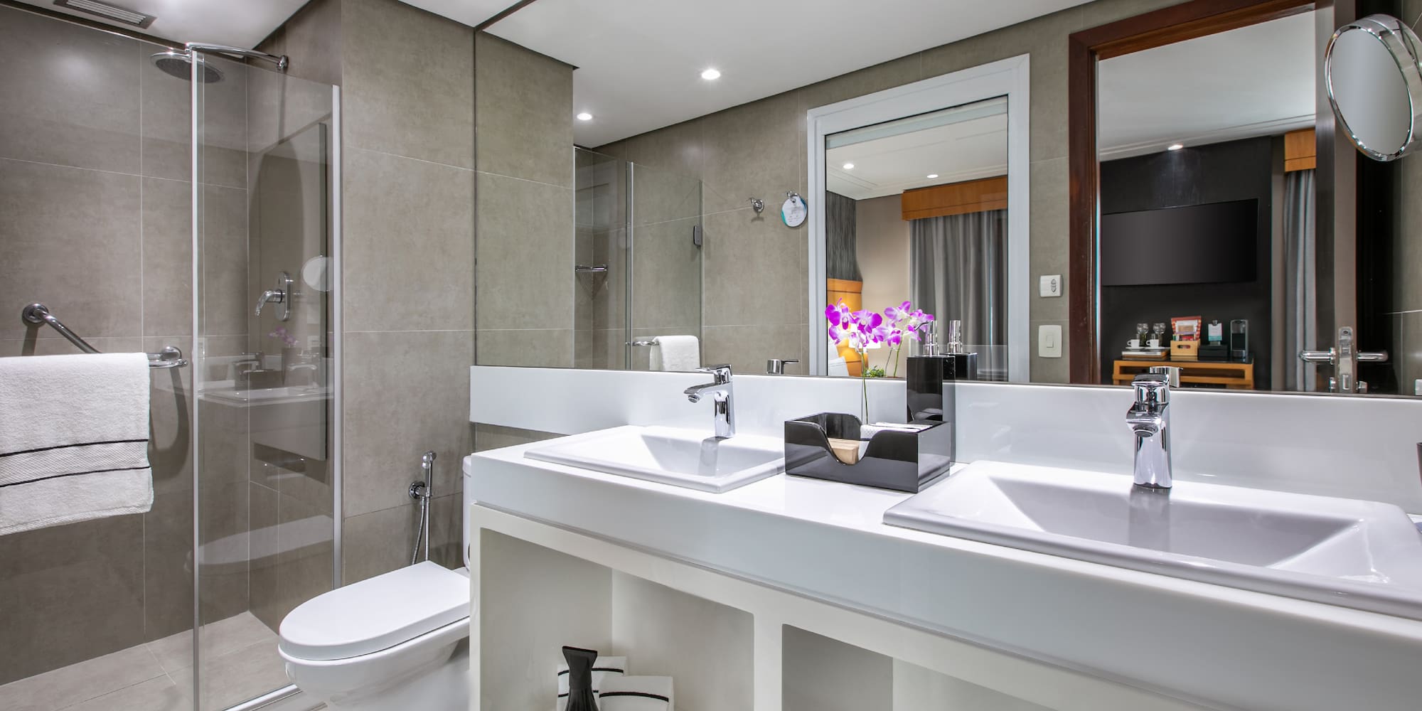 a bathroom with two sinks and a shower