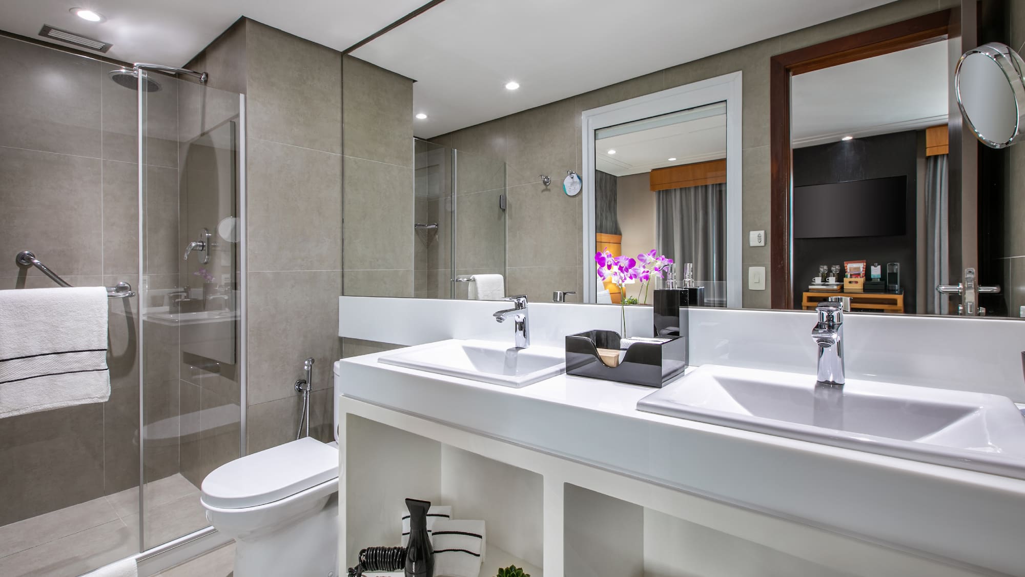 a bathroom with two sinks and a shower
