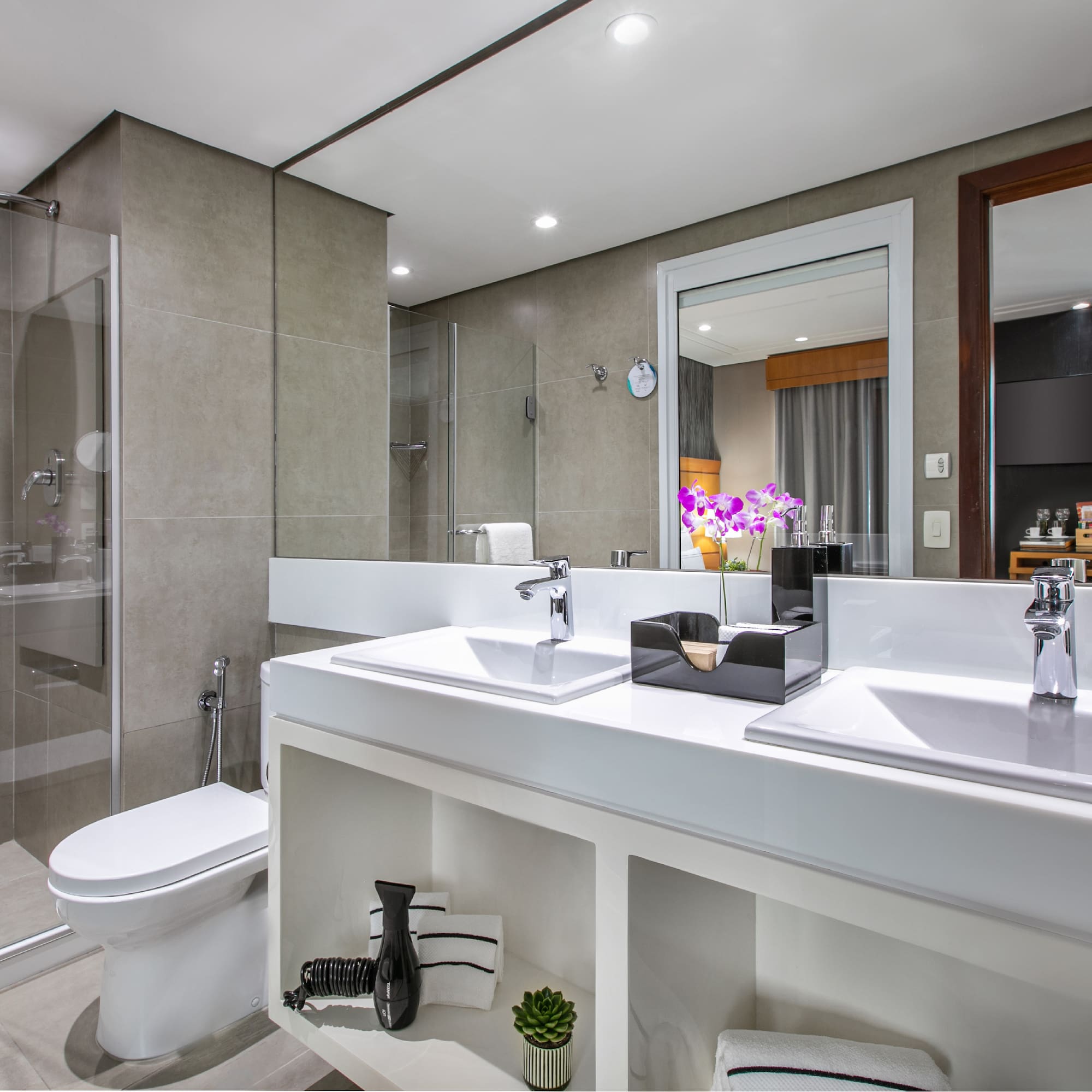a bathroom with two sinks and a shower