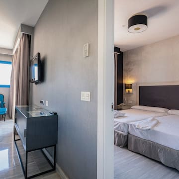 a room with a bed and a tv