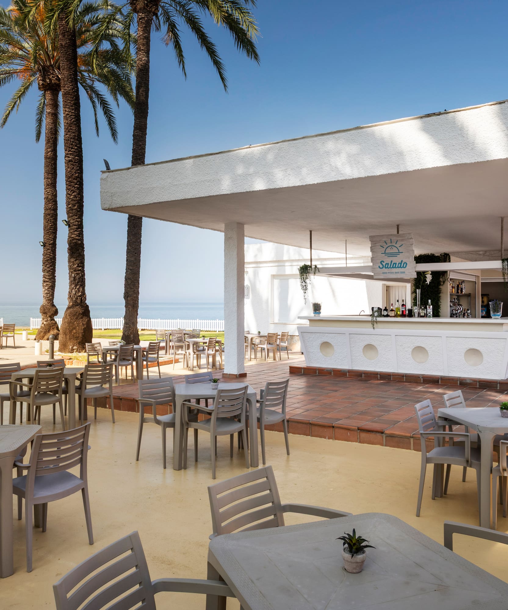 a white building with tables and chairs
