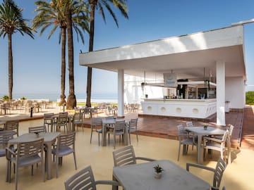 a white building with tables and chairs