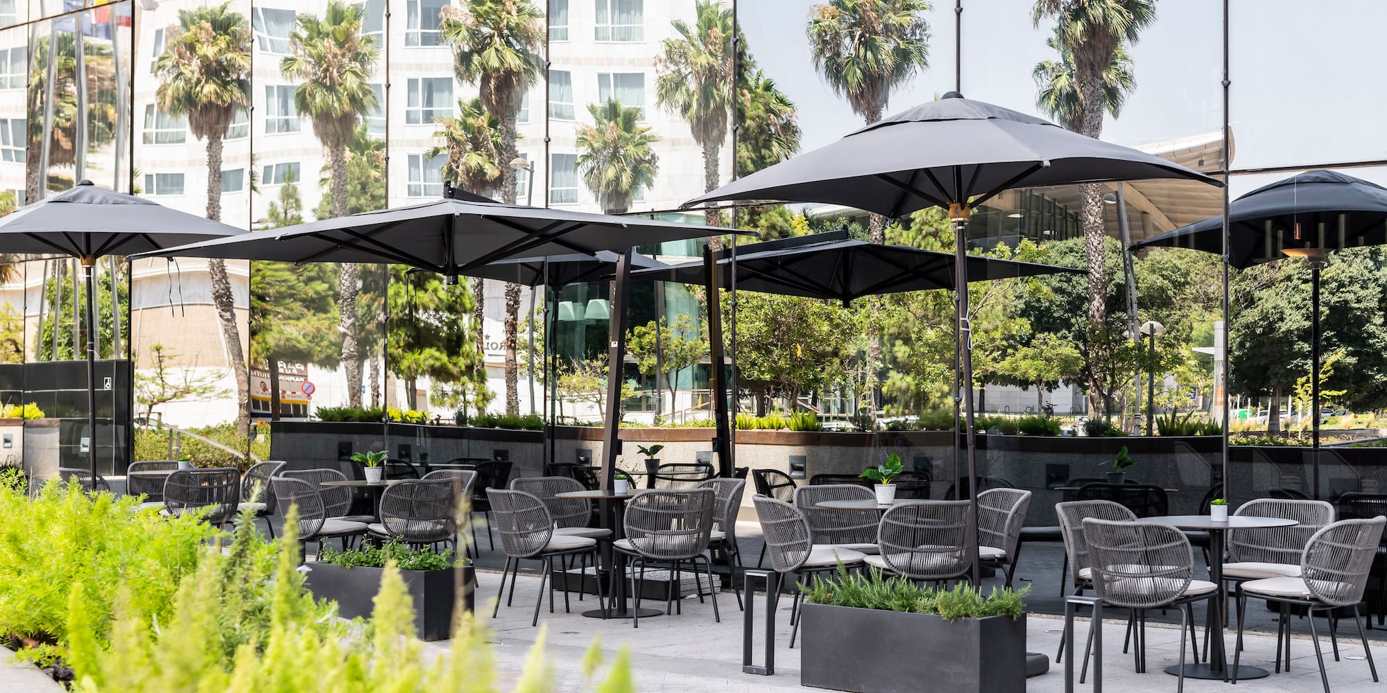 a patio area with tables and umbrellas