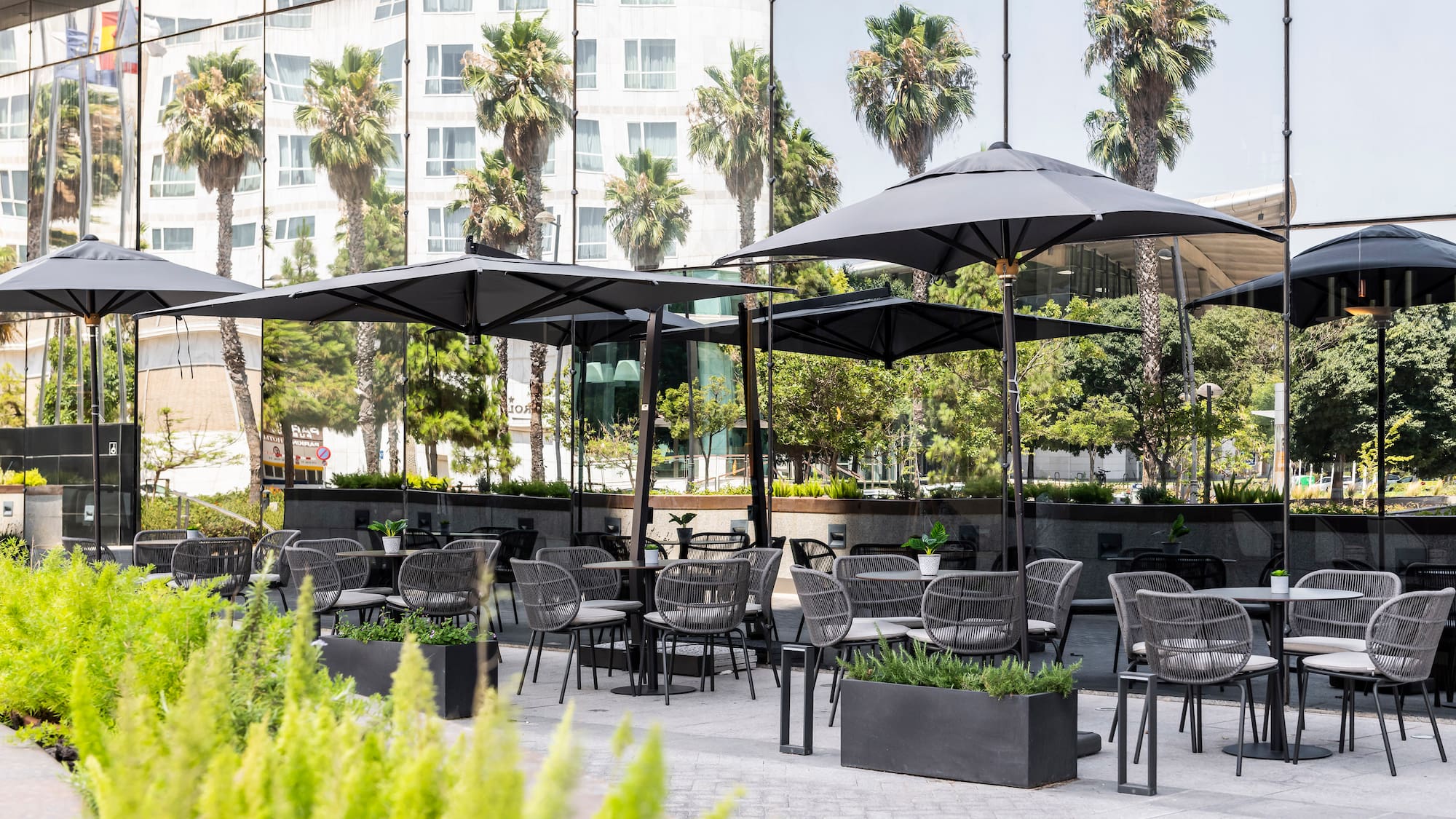 a patio area with tables and umbrellas