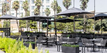 a patio area with tables and umbrellas