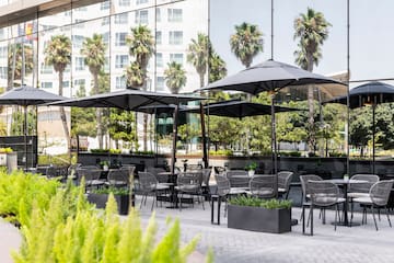 a patio area with tables and umbrellas