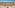a table with fruit on it and chairs on a balcony overlooking the ocean