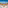 a table with fruit on it and chairs on a balcony overlooking the ocean