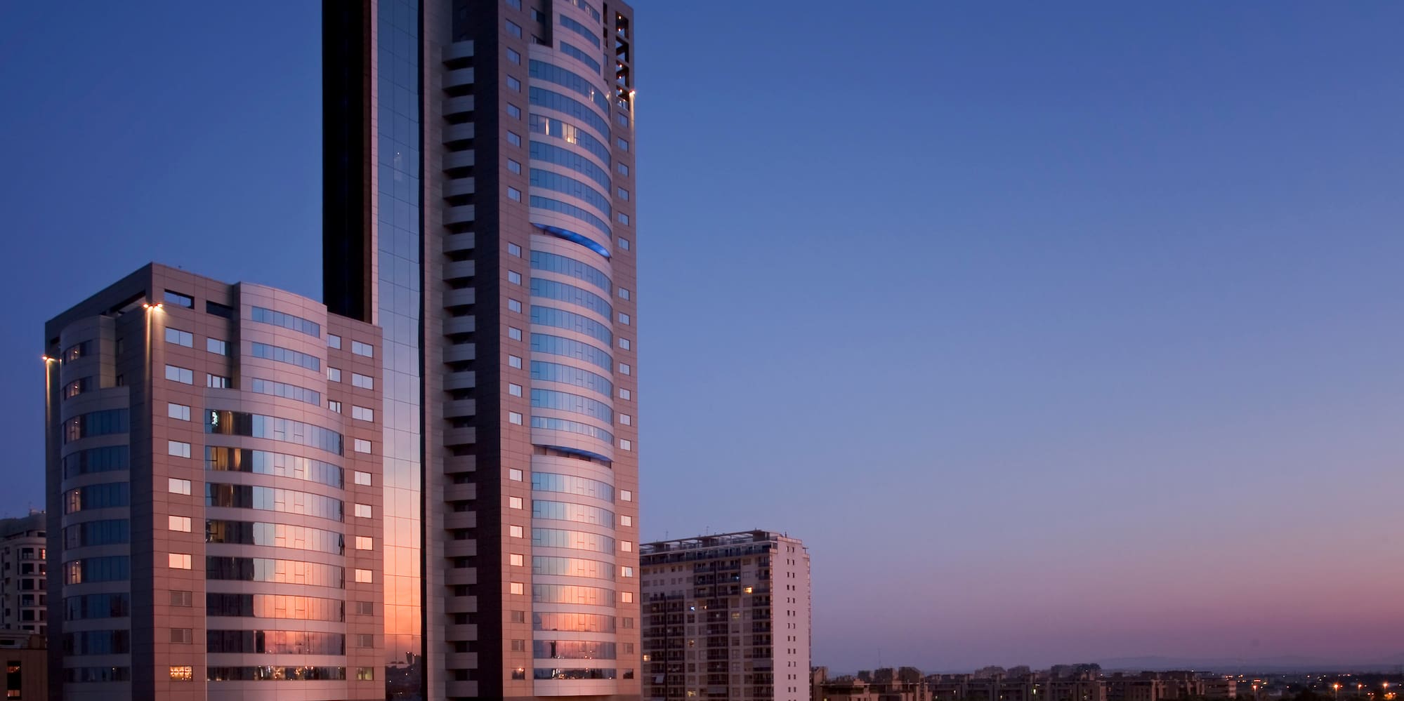 a city with tall buildings and a fountain