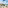 a beach with a building and trees and a body of water