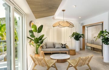 a room with a couch and chairs