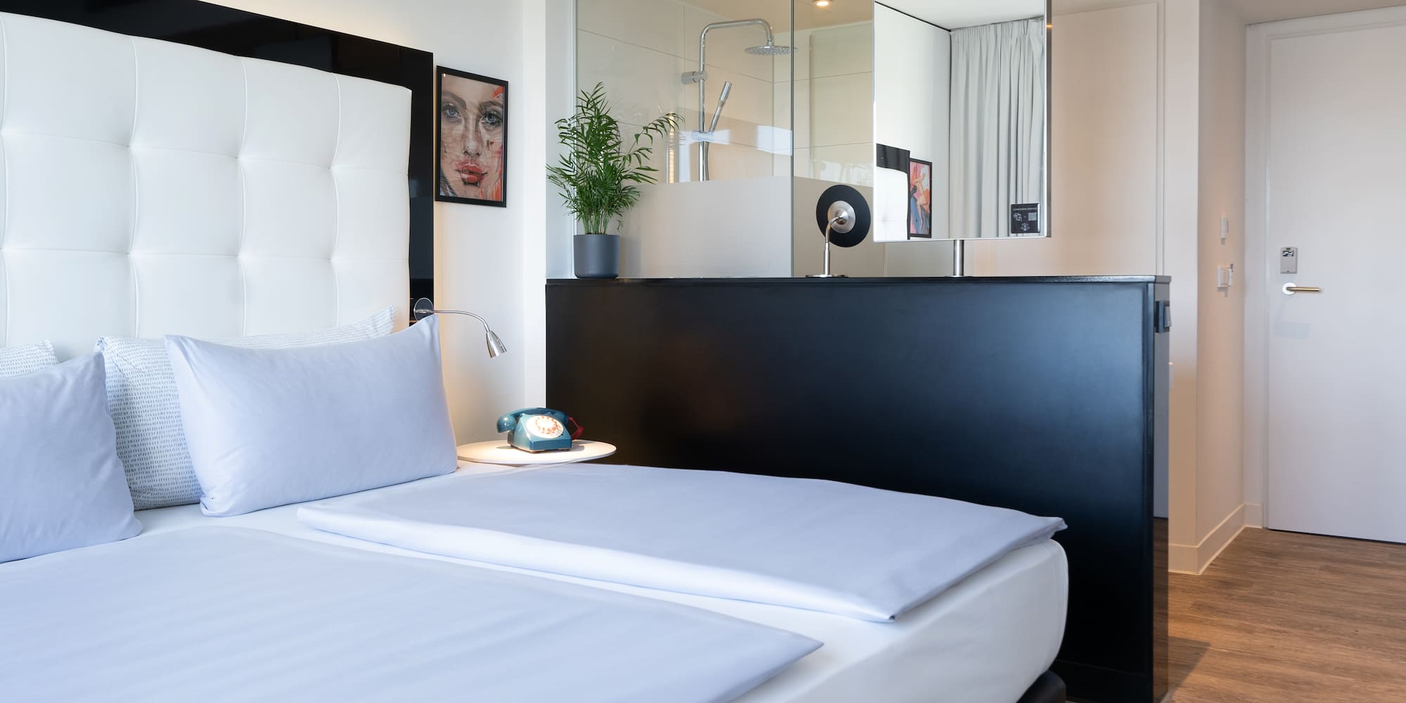 a bedroom with a mirror and a bed