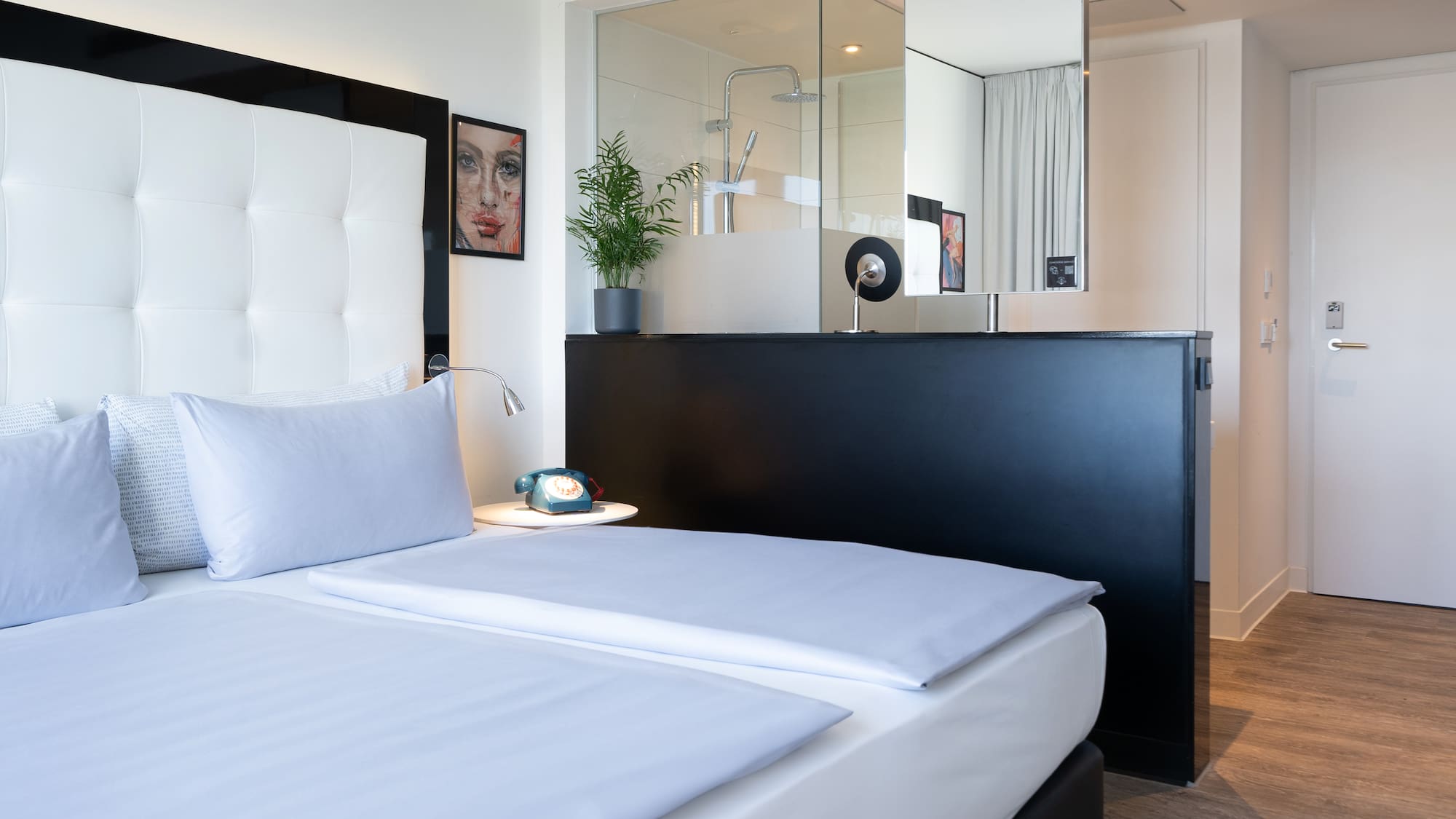 a bedroom with a mirror and a bed