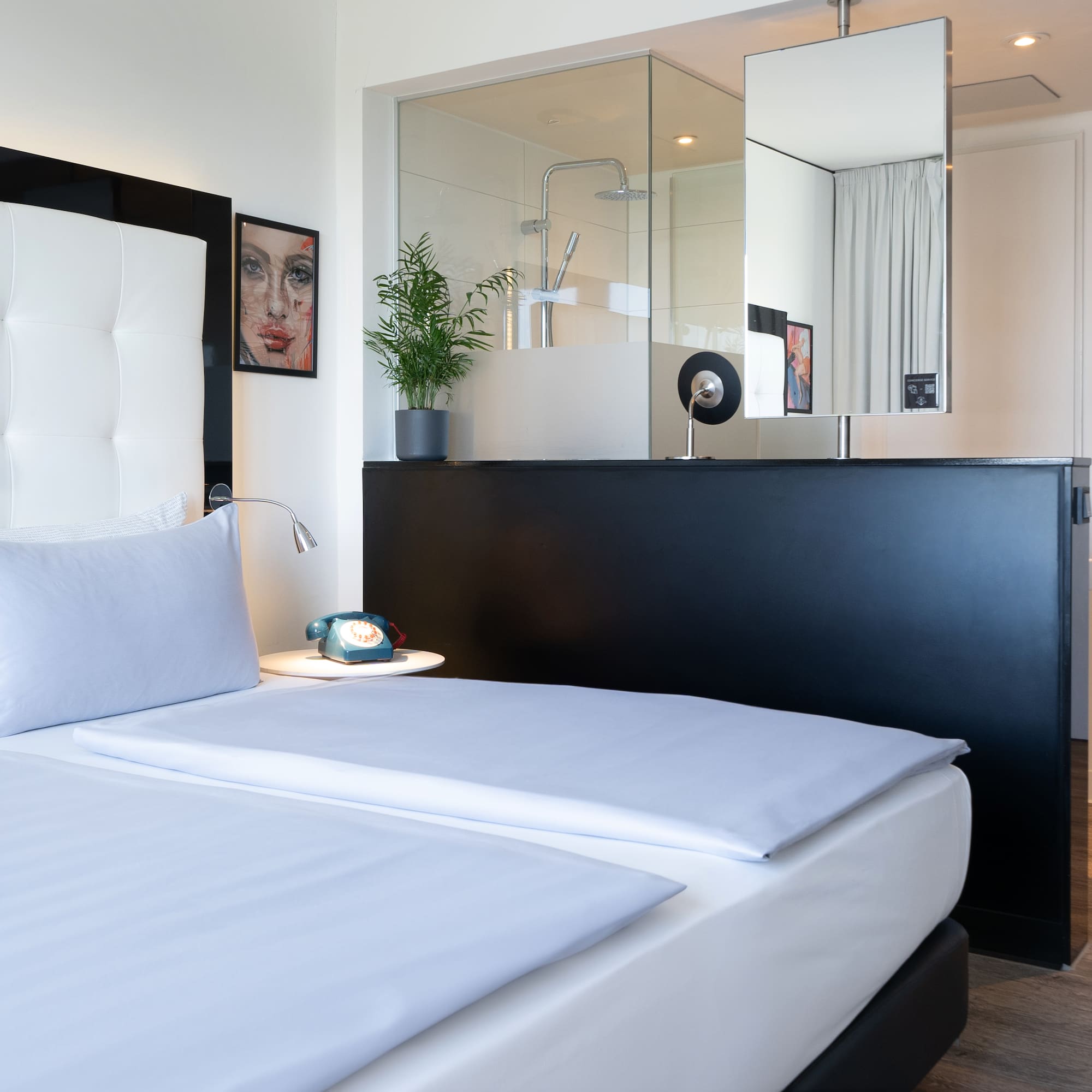 a bedroom with a mirror and a bed