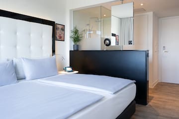 a bedroom with a mirror and a bed