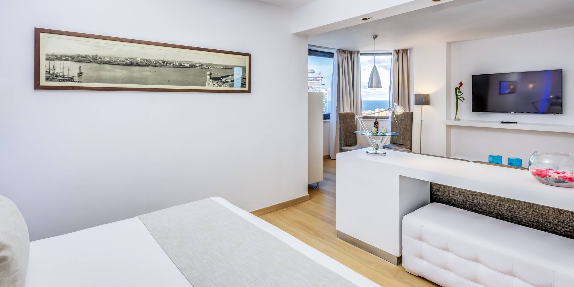 a room with a bed and a tv