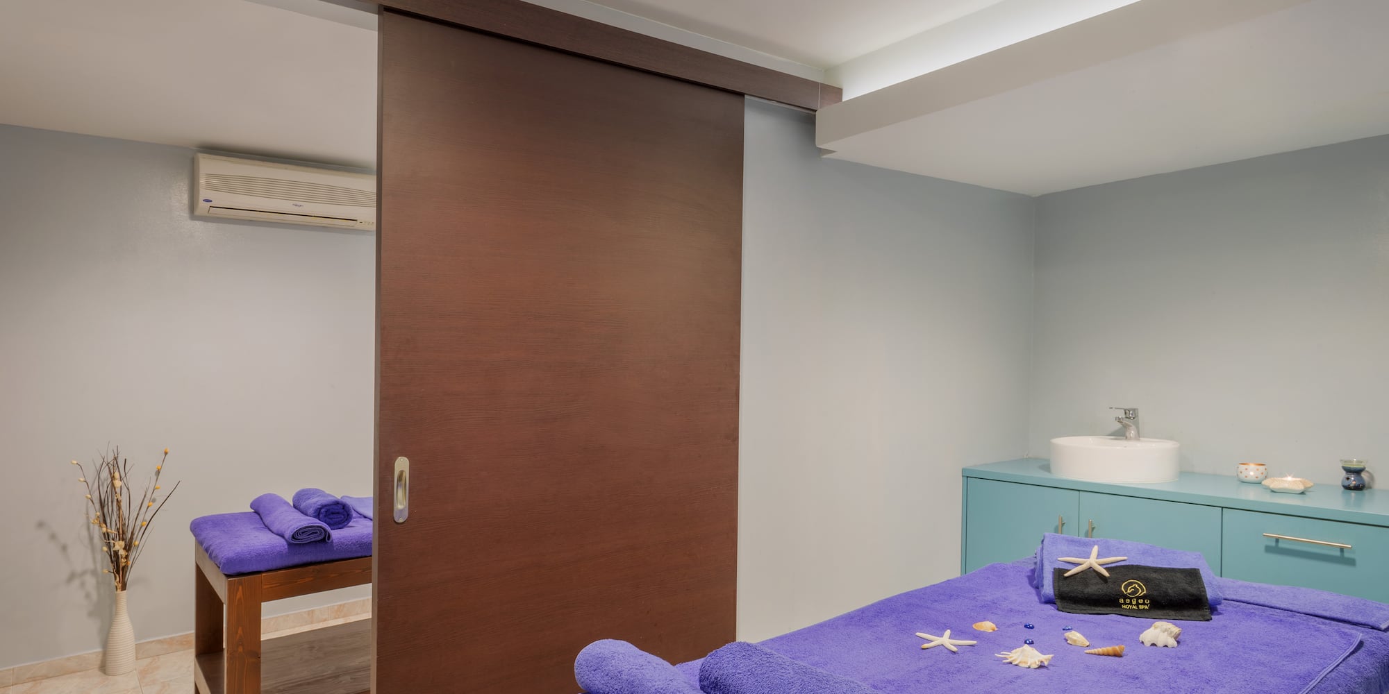 a room with a bed and towels