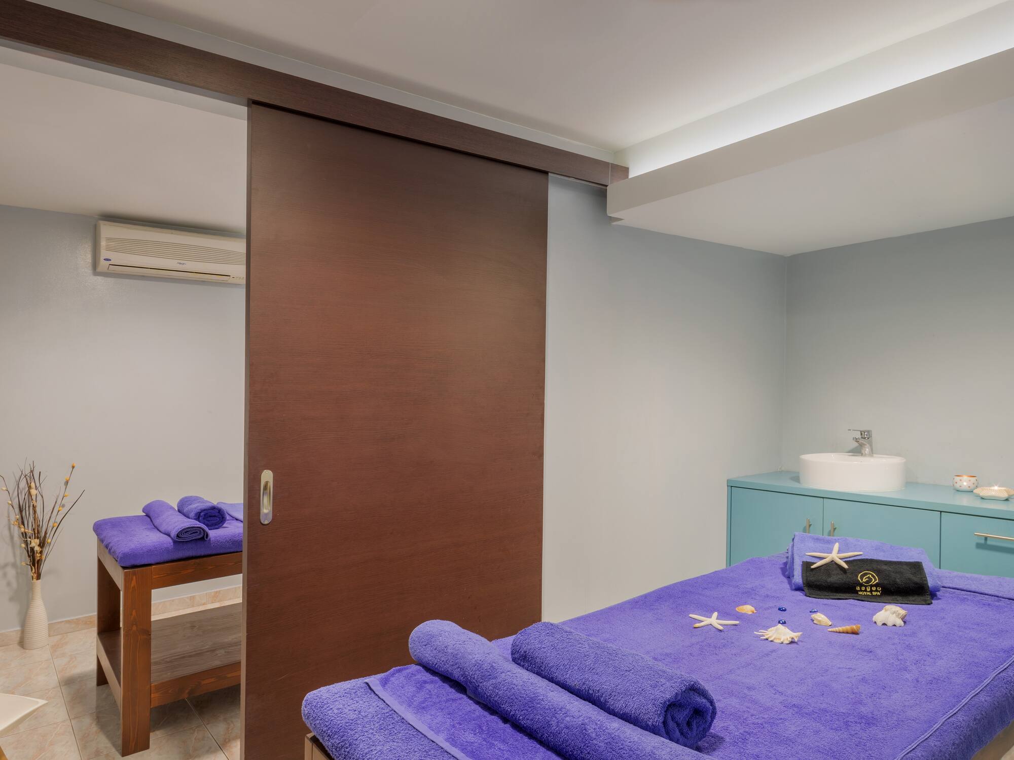 a room with a bed and towels