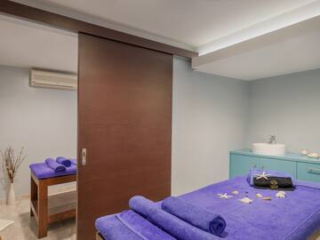 a room with a bed and towels