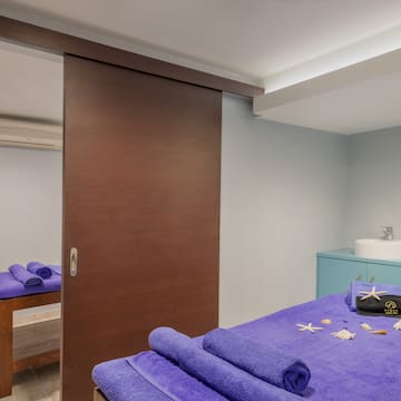 a room with a bed and towels