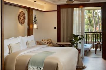 a bedroom with a bed and a tub