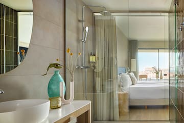 a bathroom with a shower and a bed