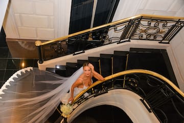 a woman in a wedding dress on a staircase