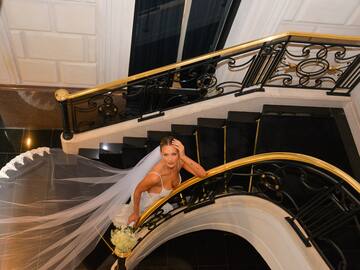 a woman in a wedding dress on a staircase
