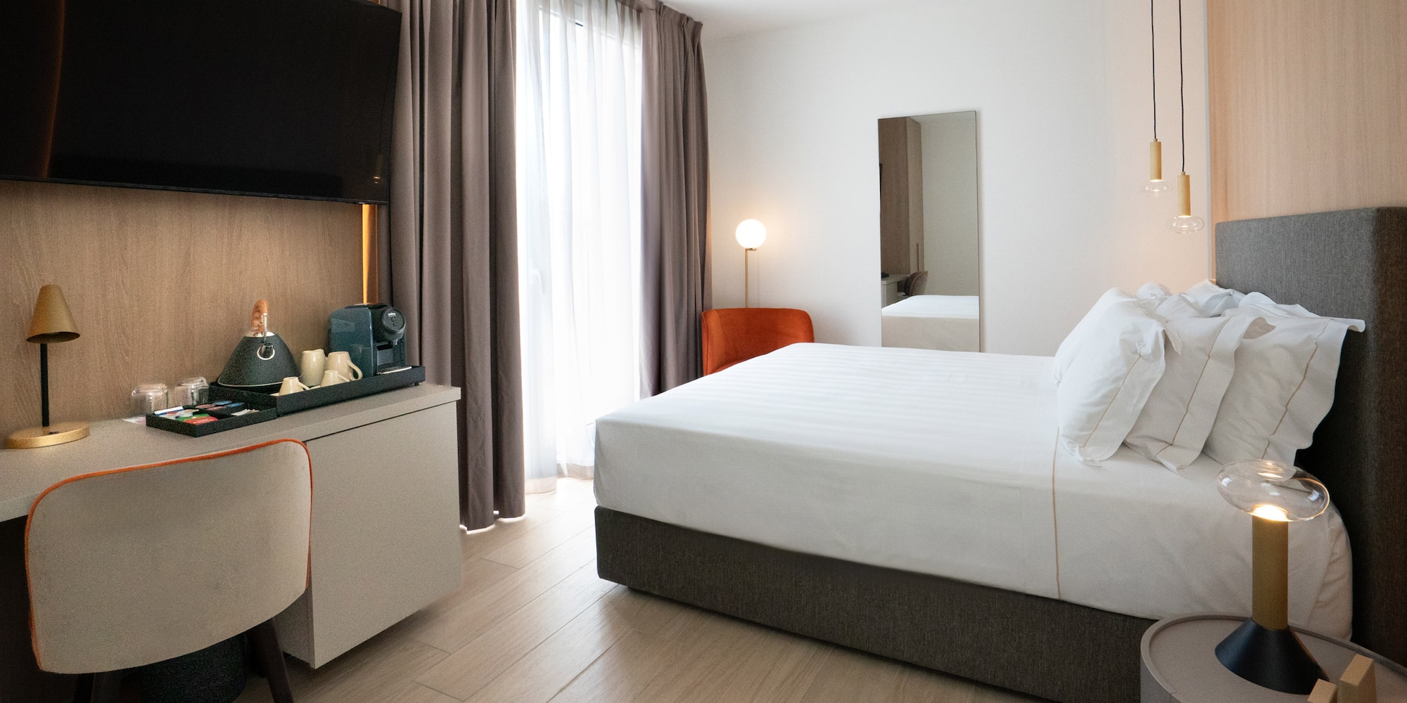 a room with a bed and a mirror